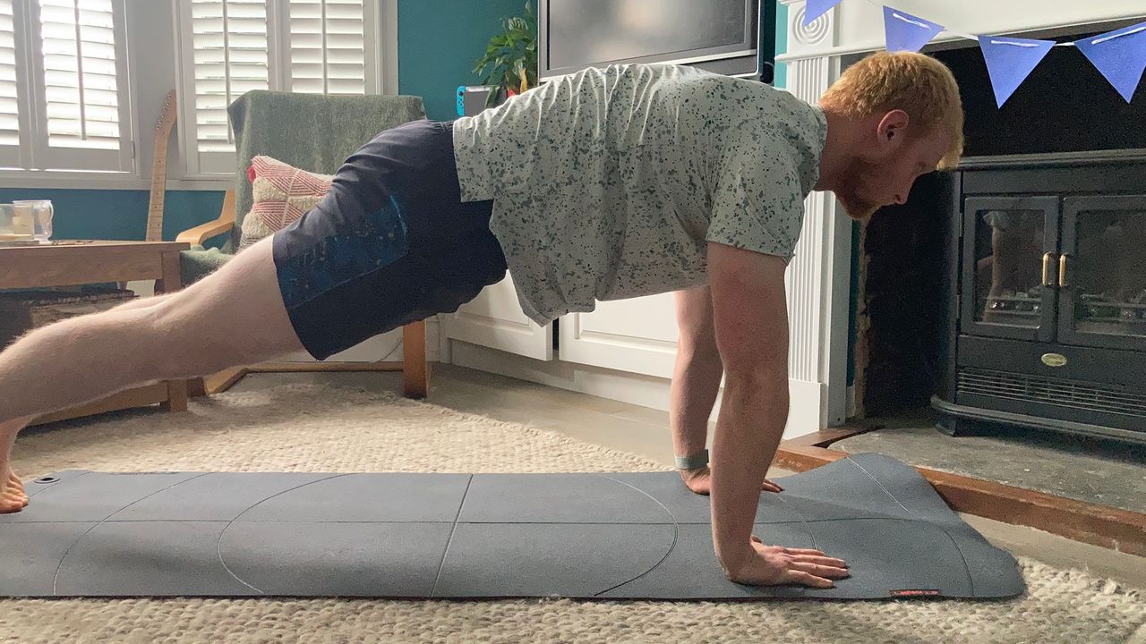 Fit &amp; Well fitness writer Harry Bullmore performing a plank up and down