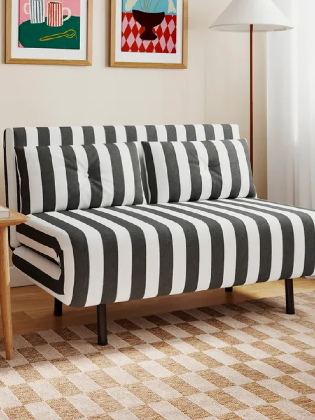 A black and white striped click clack sofa