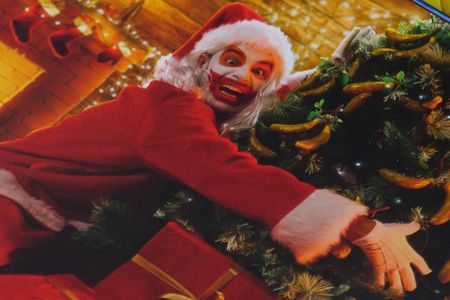 Jimbo as Santa hugging a Christmas tree