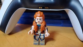 LEGO Aloy in front of DualSense controller