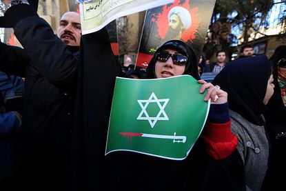 An Iranian woman protests against Saudi Arabia