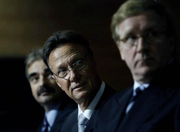 Members of the independent Vogelzang committee look on as their findings are presented to the media.