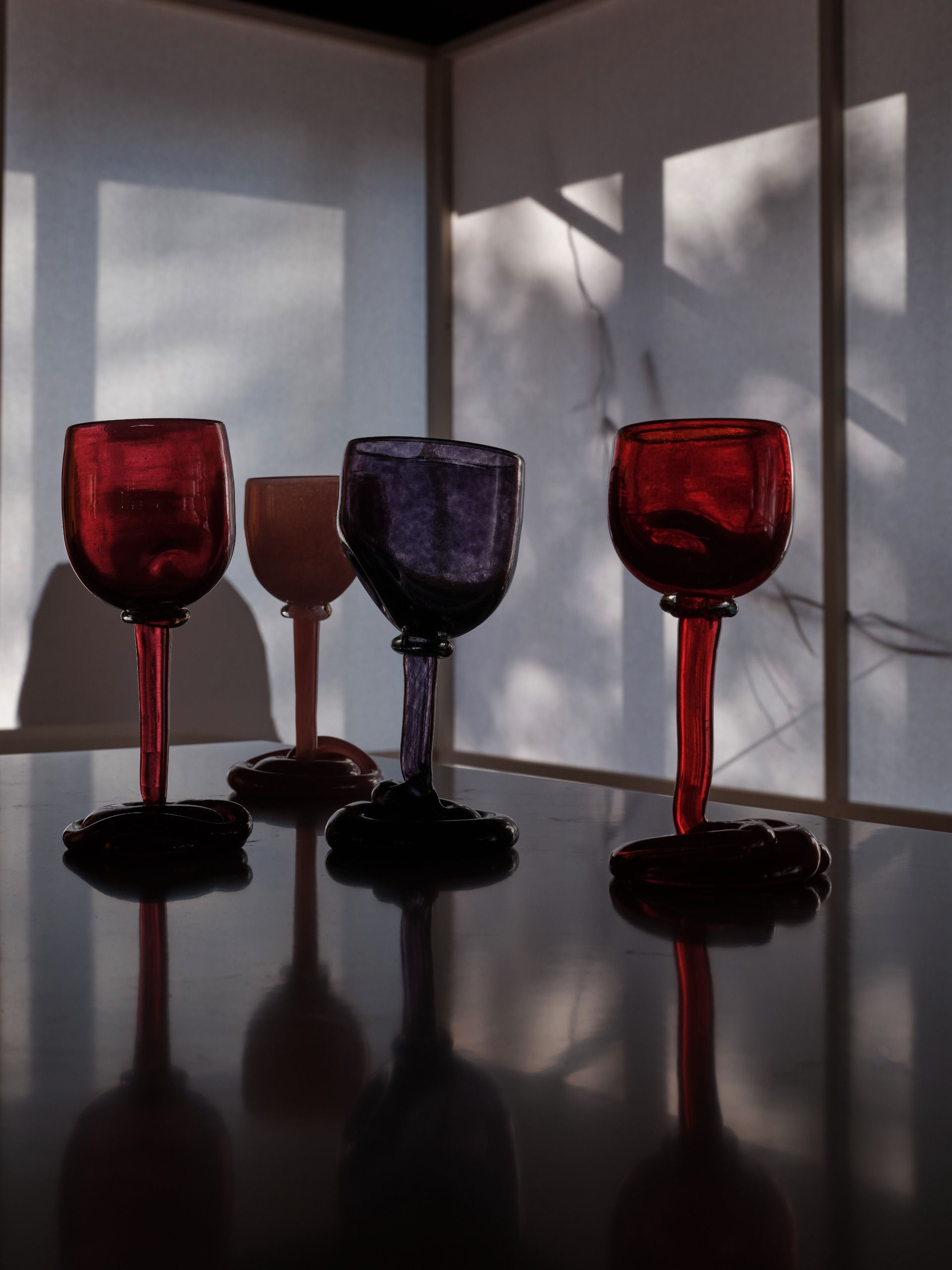 A series of accessories and tableware item featuring a melting-like silhouette with uneven surfaces and inflated volumes.