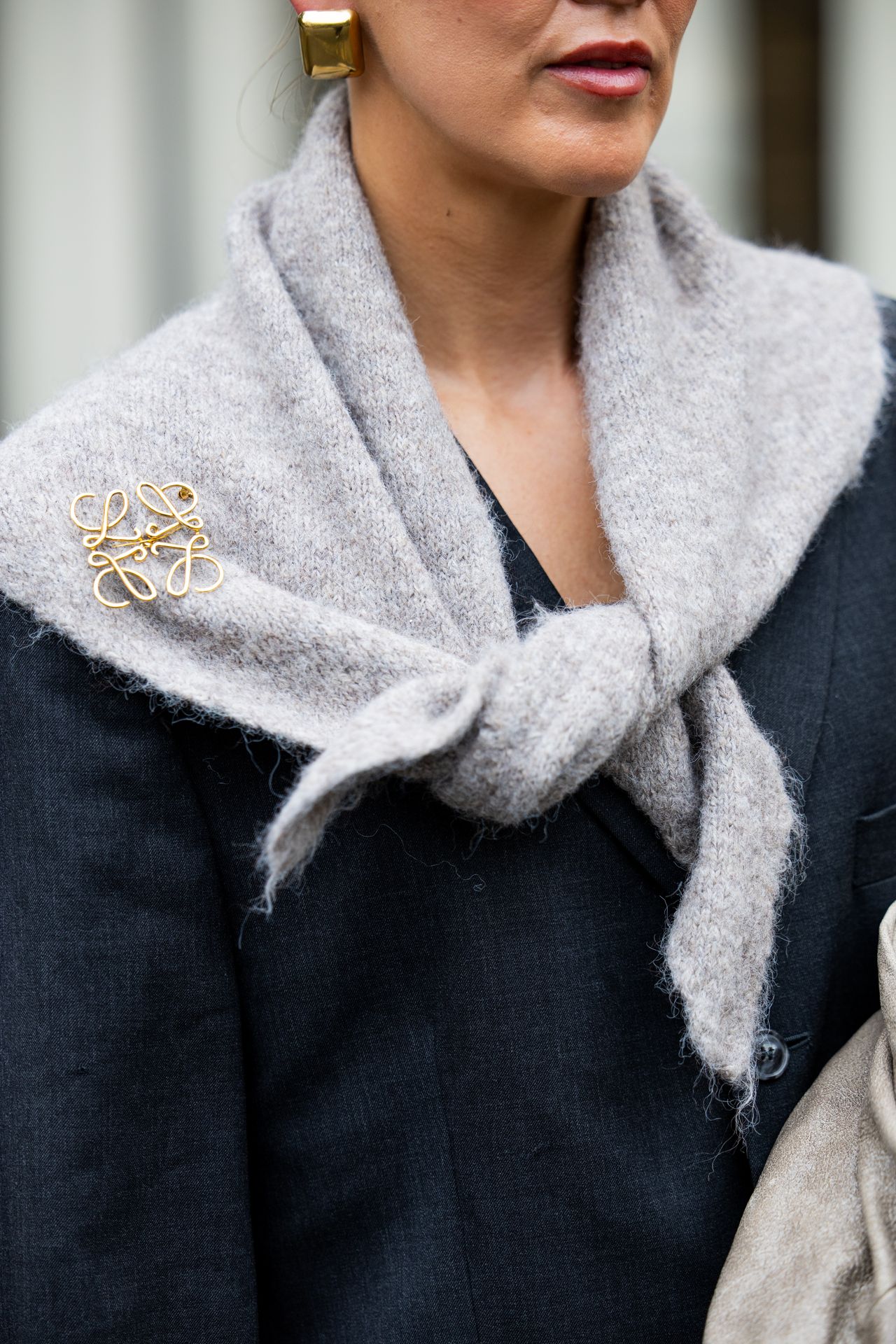 BERLIN, GERMANY - OCTOBER 08: Tina Haase wears vintage black oversize blazer, Black stirrup leggings, taupe knit triangle scarf Massimo Dutti, Loewe brooch, taupe grey Prada Bag on October 08, 2025 in Berlin, Germany. (Photo by Christian Vierig/Getty Images)
