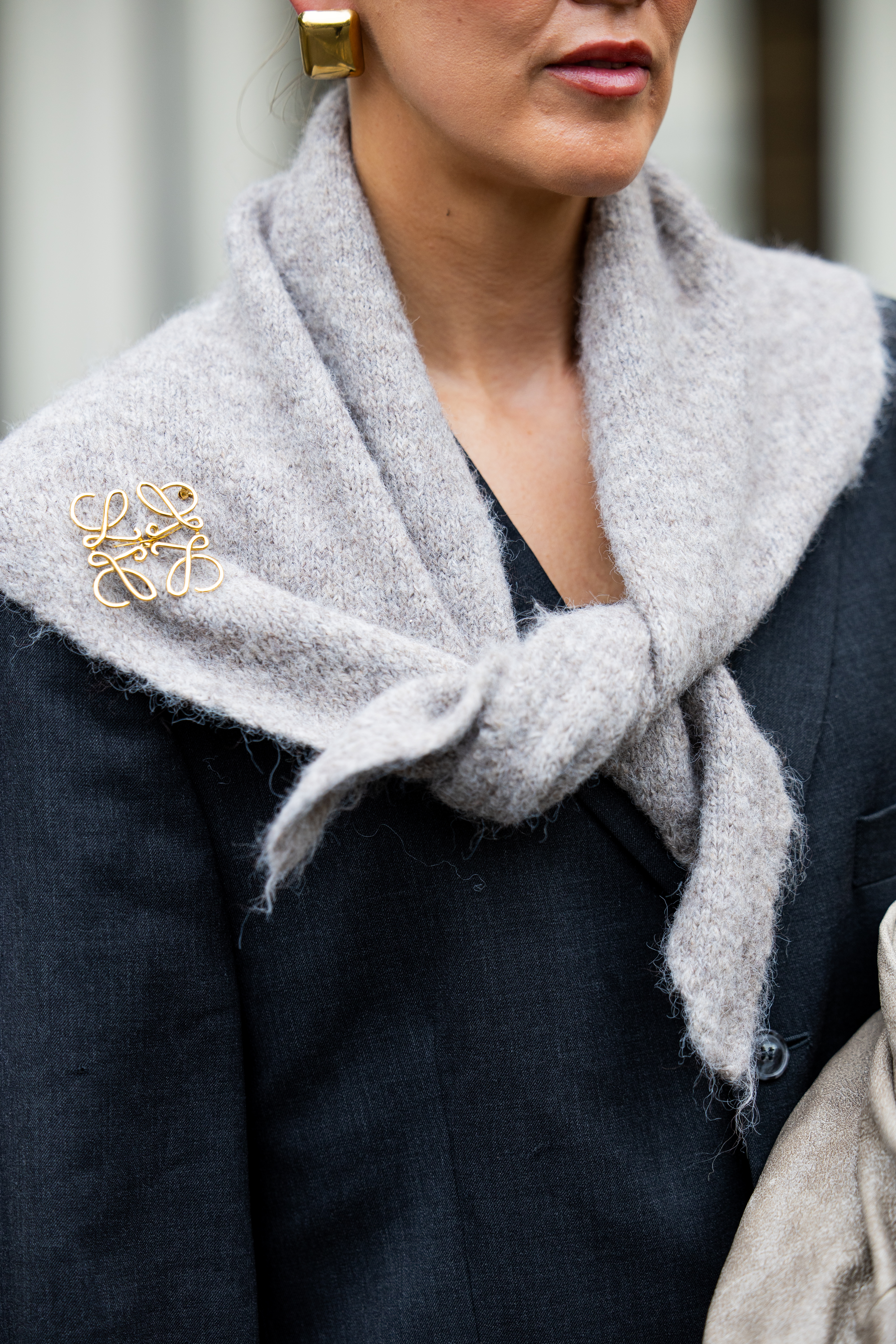 BERLIN, GERMANY - OCTOBER 08: Tina Haase wears vintage black oversize blazer, Black stirrup leggings, taupe knit triangle scarf Massimo Dutti, Loewe brooch, taupe grey Prada Bag on October 08, 2025 in Berlin, Germany. (Photo by Christian Vierig/Getty Images)