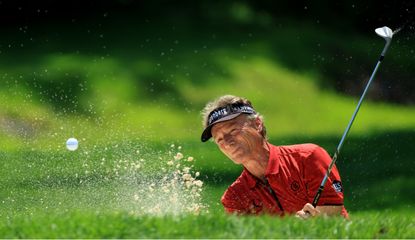 Langer hits a shot from the bunker