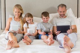Family with phone and tablets