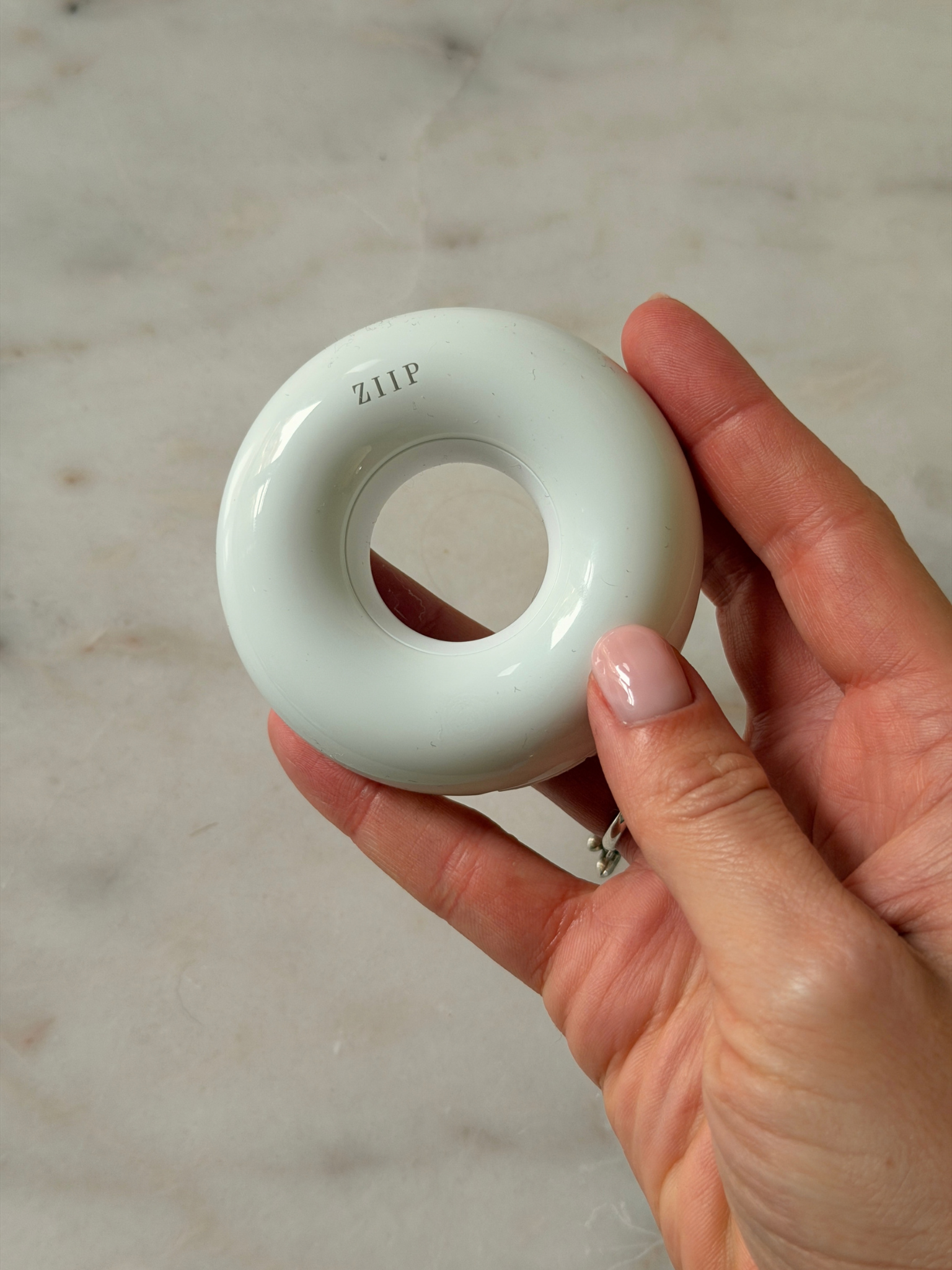Freelance beauty editor Grace Day holding the ZIIP Dot spot treatment