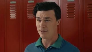Finn Wittrock's Coach Laidlow standing in front of red lockers in Downtown Owl