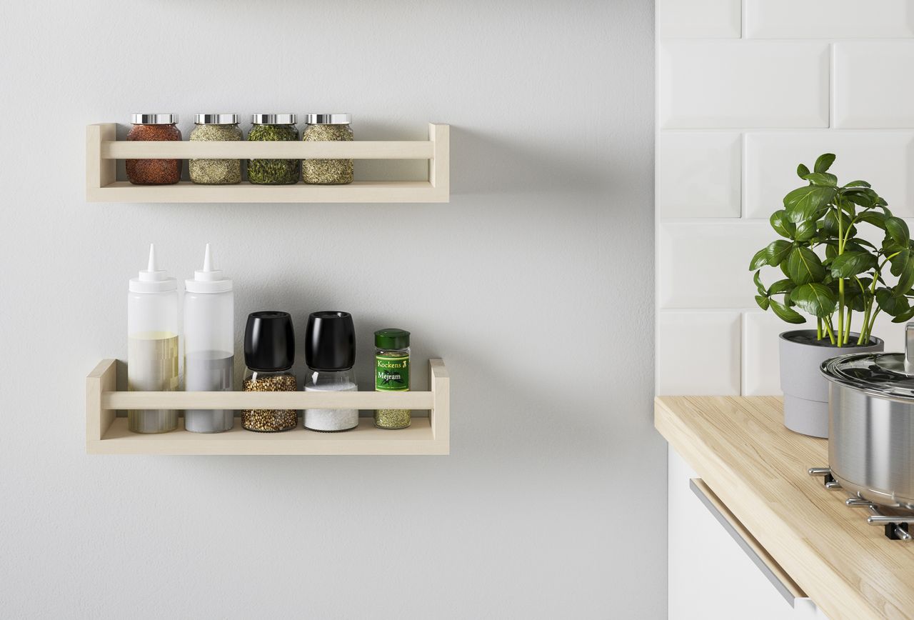 A kitchen with two wooden spice racks mounted on the walls