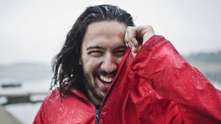 hardshell vs softshell: man in waterproof jacket laughing