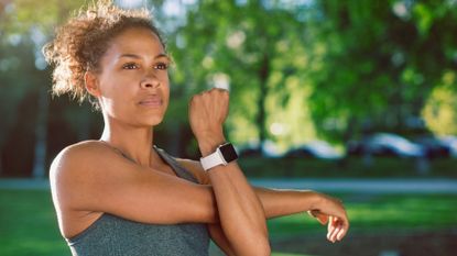 How to tone arms fast: Image shows woman stretching arms 