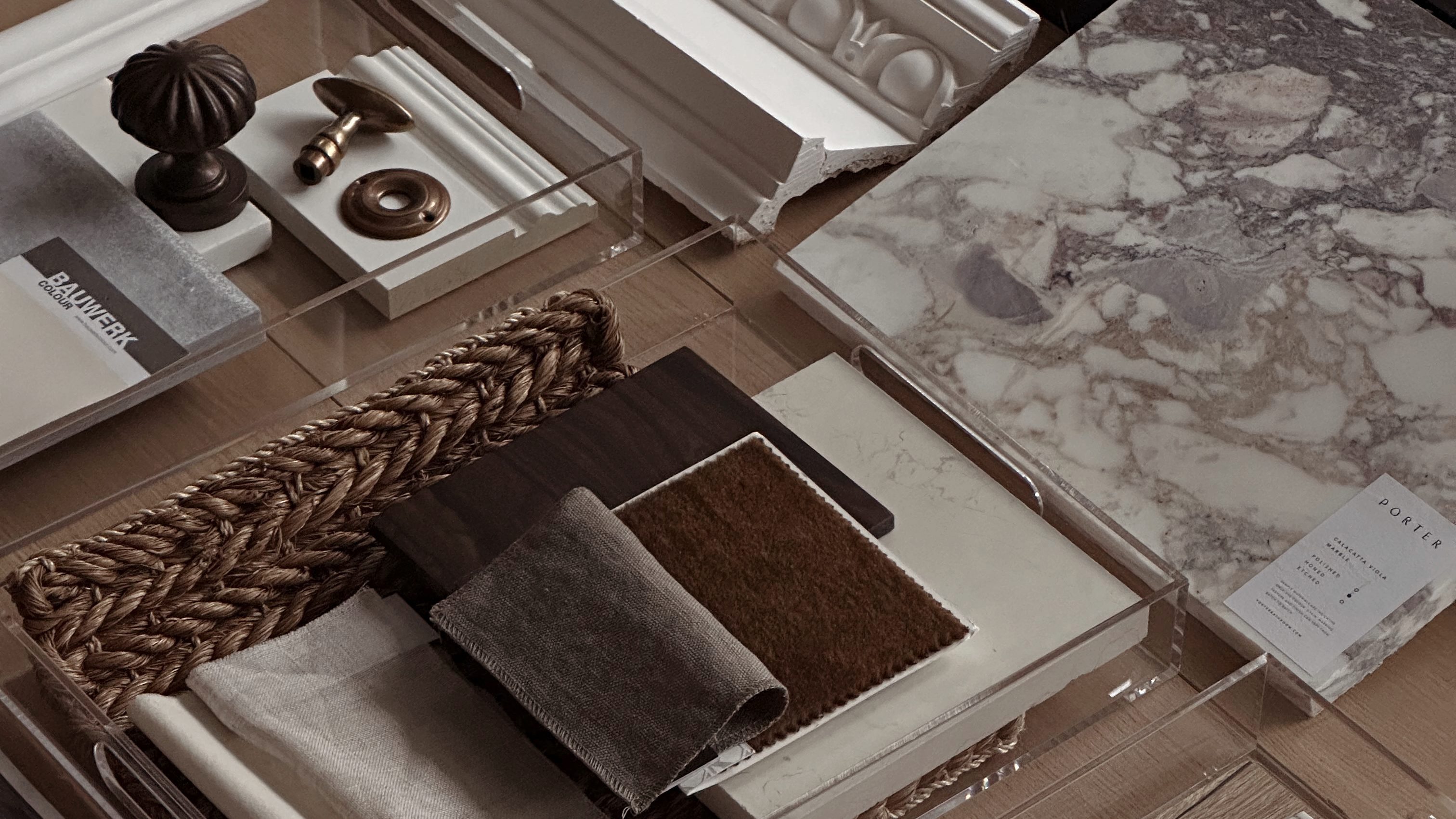 swatches of fabric and samples of hardware laid out like a moodboard