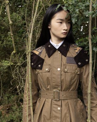 Model in belted wax jacket