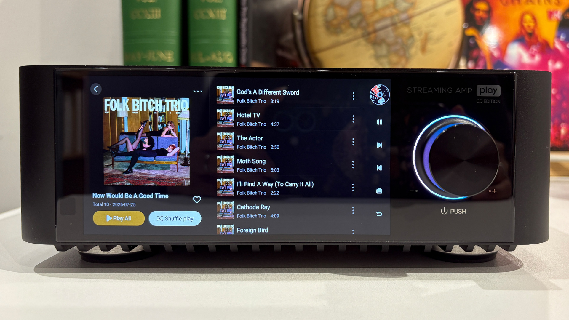 Eversolo Play CD Edition streaming amp/CD player, on screen is music player listing and Folk Bitch Trio artwork
