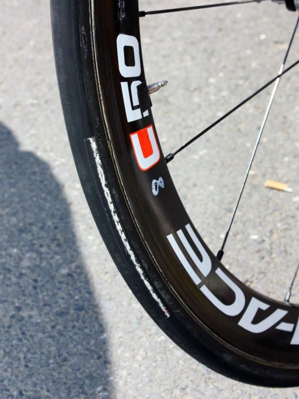This isn't an attempt by Francaise des Jeux mechanics to scrape off a tire label - it's simply the result of very aggressive cornering.