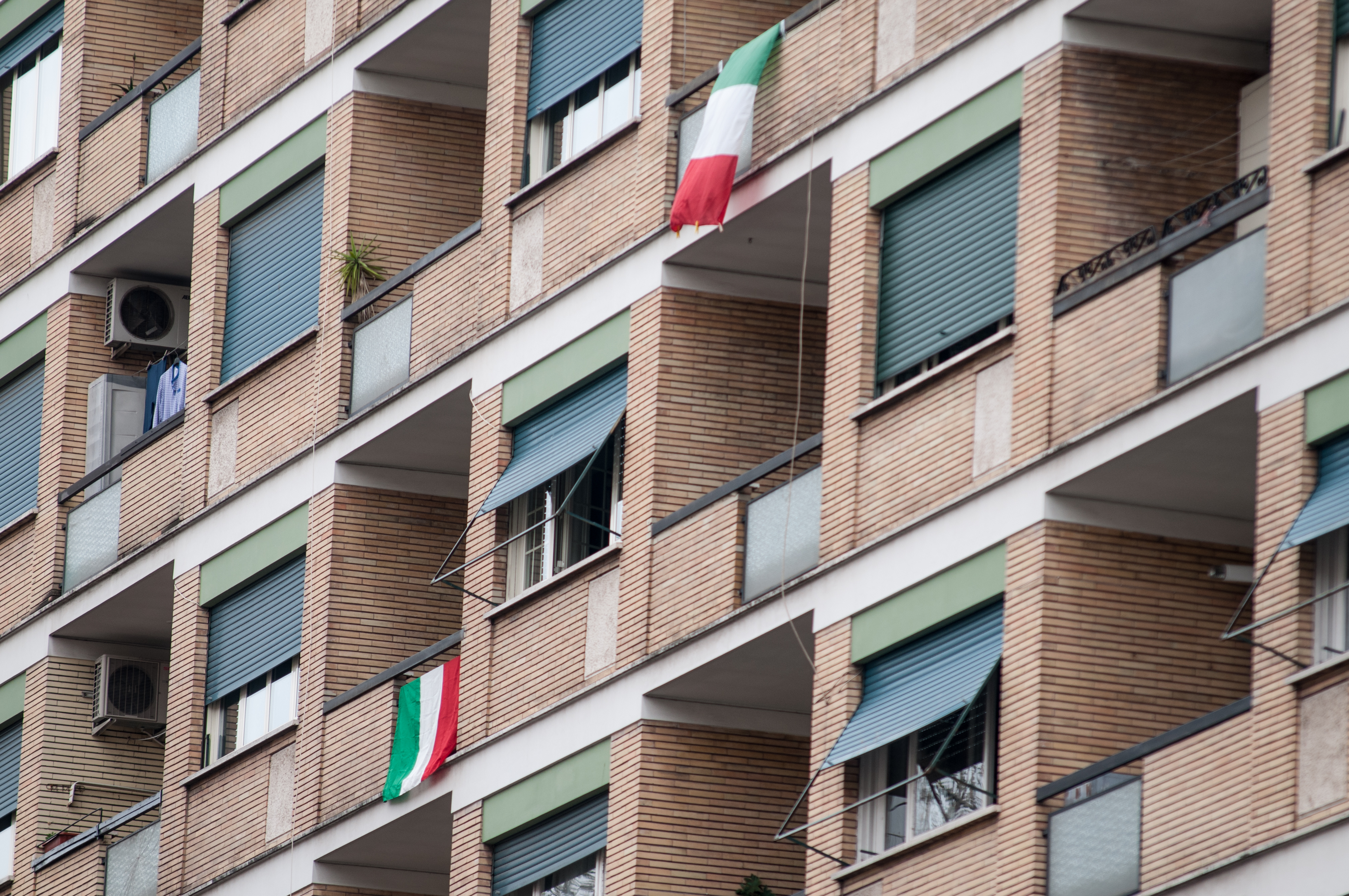 section of Rome apartment facade with recessed blaconies