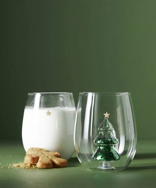 Anthropologie Yuletide Stemless Glasses, one filled with milk next to a gingerbread man