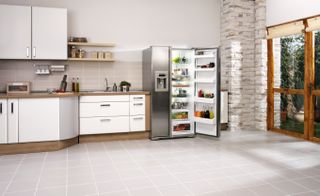 A minimalist kitchen with an open fridge-freezer