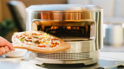My favorite of the best Ooni alternatives, a Solo Stove Pi pizza oven ready to be loaded with a vegetable pizza