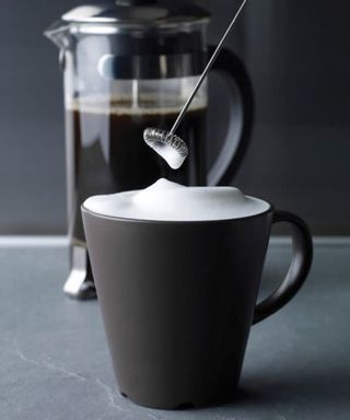 Aerolatte satin milk frother with black coffee cup and cafetiere