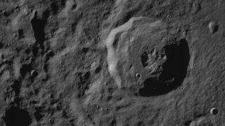 a close-up of the lunar surface showing a crater