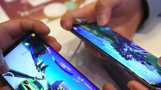 Two people playing games on samsung phones. 