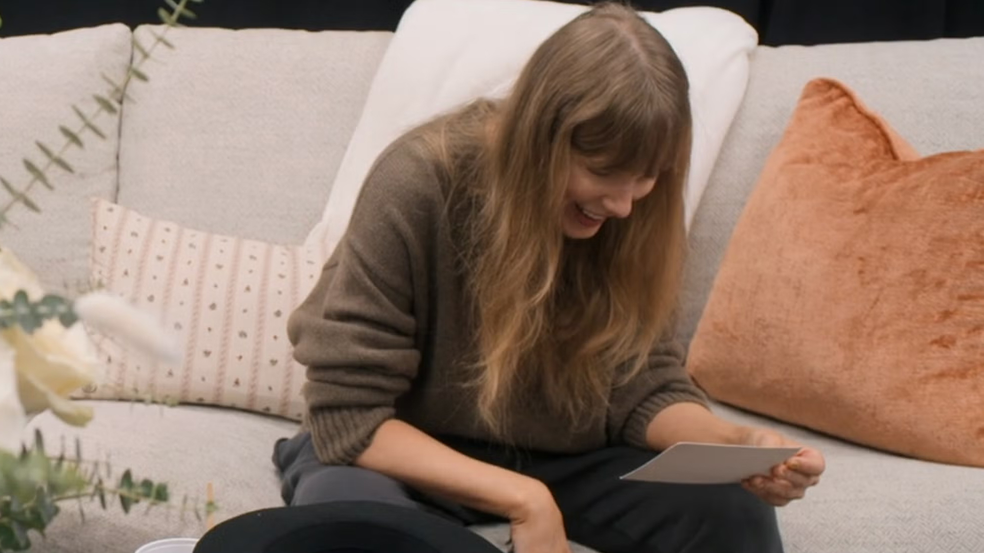Taylor Swift reading a letter from Travis Kelce in episode six of her docuseries, The End of an Era.