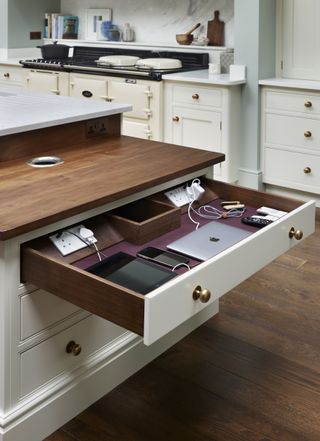 iPad and devices plugged inside a drawer in a kitchen