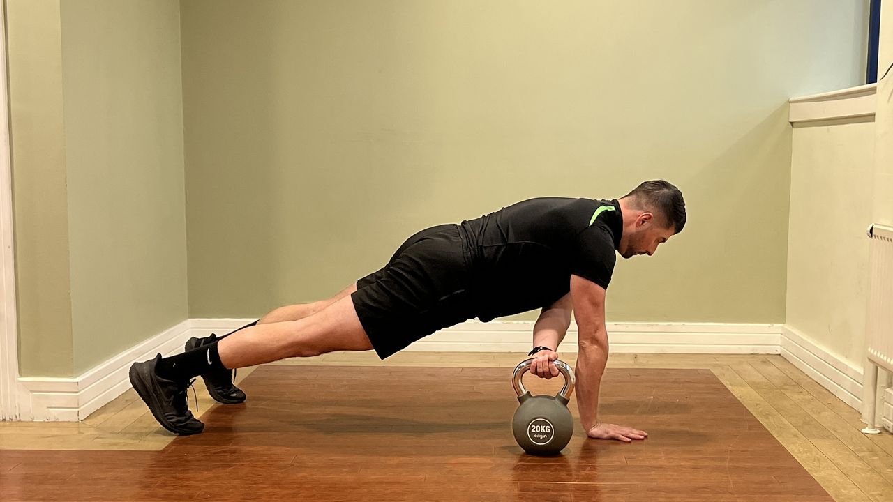 Sam Quinn, strength coach from Nuffield Health, demonstrates a kettlebell pull through