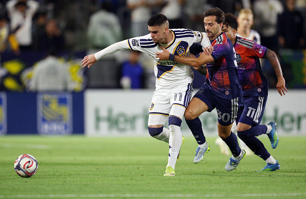 CARSON, CALIFORNIA - MAY 23: Gabriel Pec #11 of Los Angeles Galaxy and Agust&amp;iacute;n Bouzat #30 of the Houston Dynamo battle for the ball during the second half at Dignity Health Sports Park on May 23, 2026 in Carson, California. (Photo by Kevork Djansezian/Getty Images)