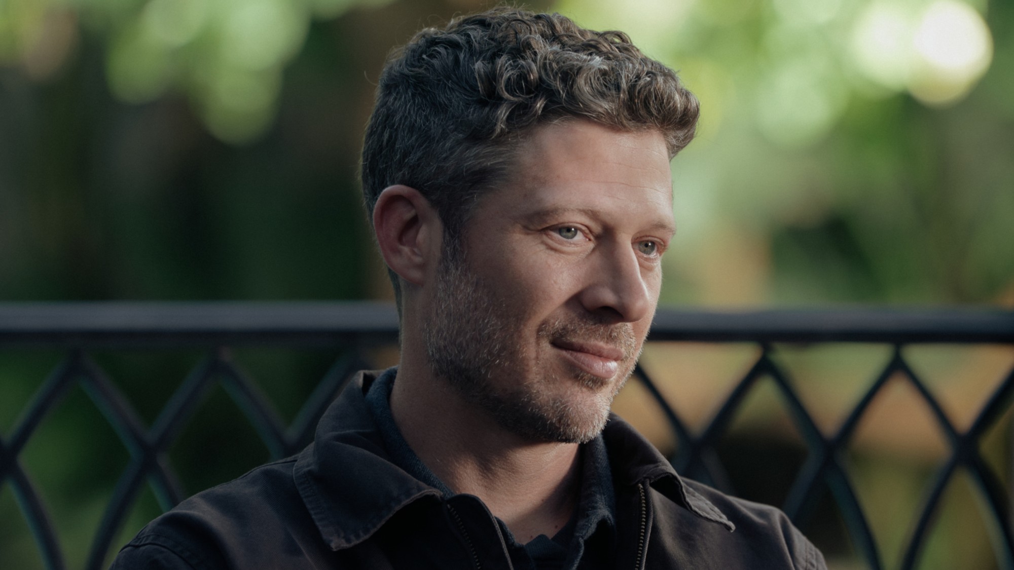 Voit sitting down and smirking in the Criminal Minds: Evolution Season 19 finale.