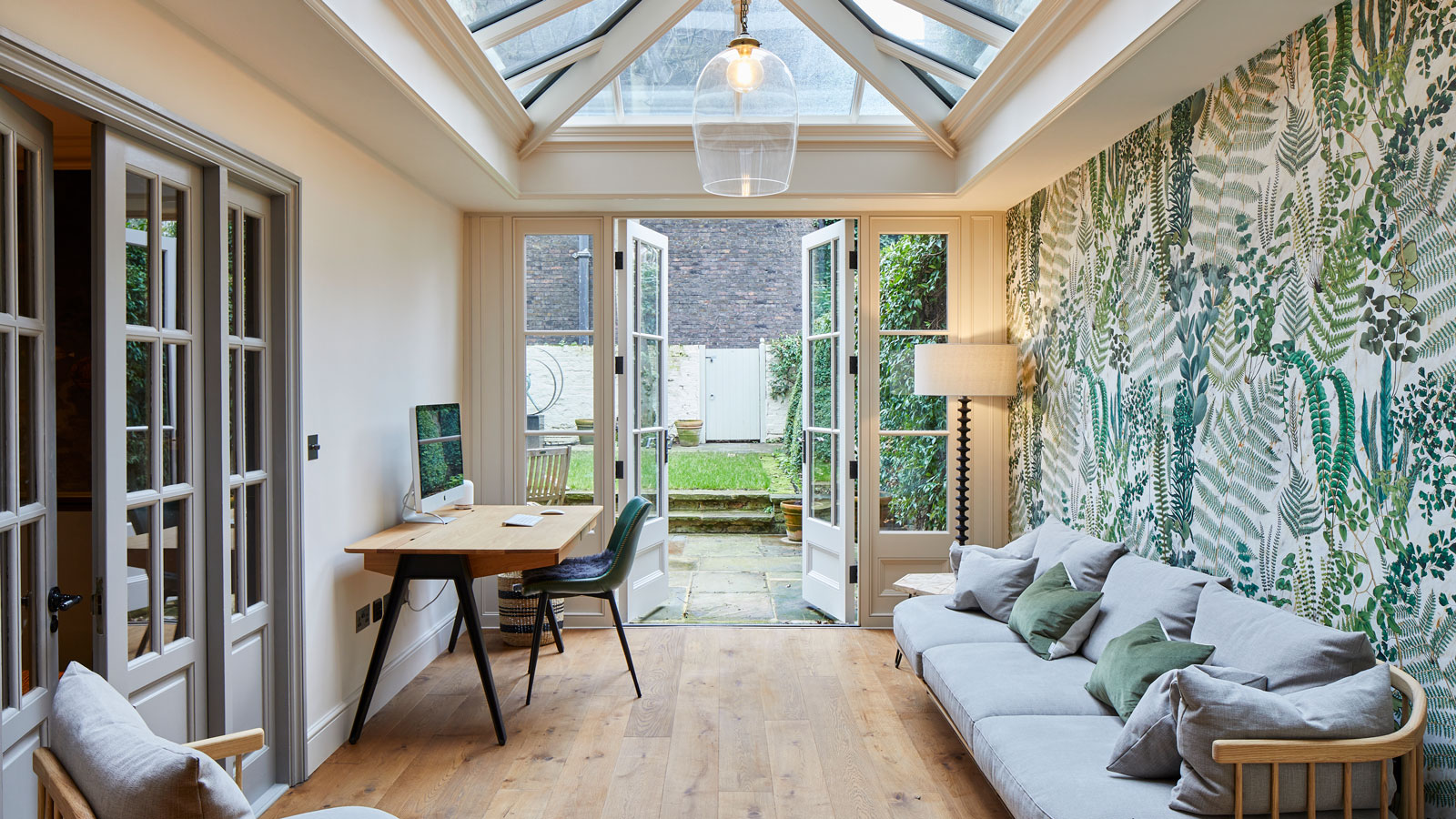 conservatory home office with French doors and wooden flooring