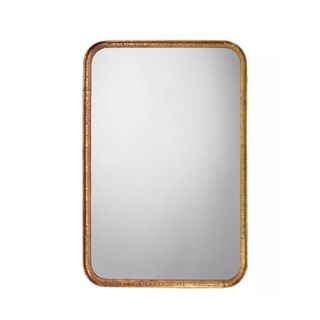A gold rectangular mirror with curved edges and glass in the middle of it