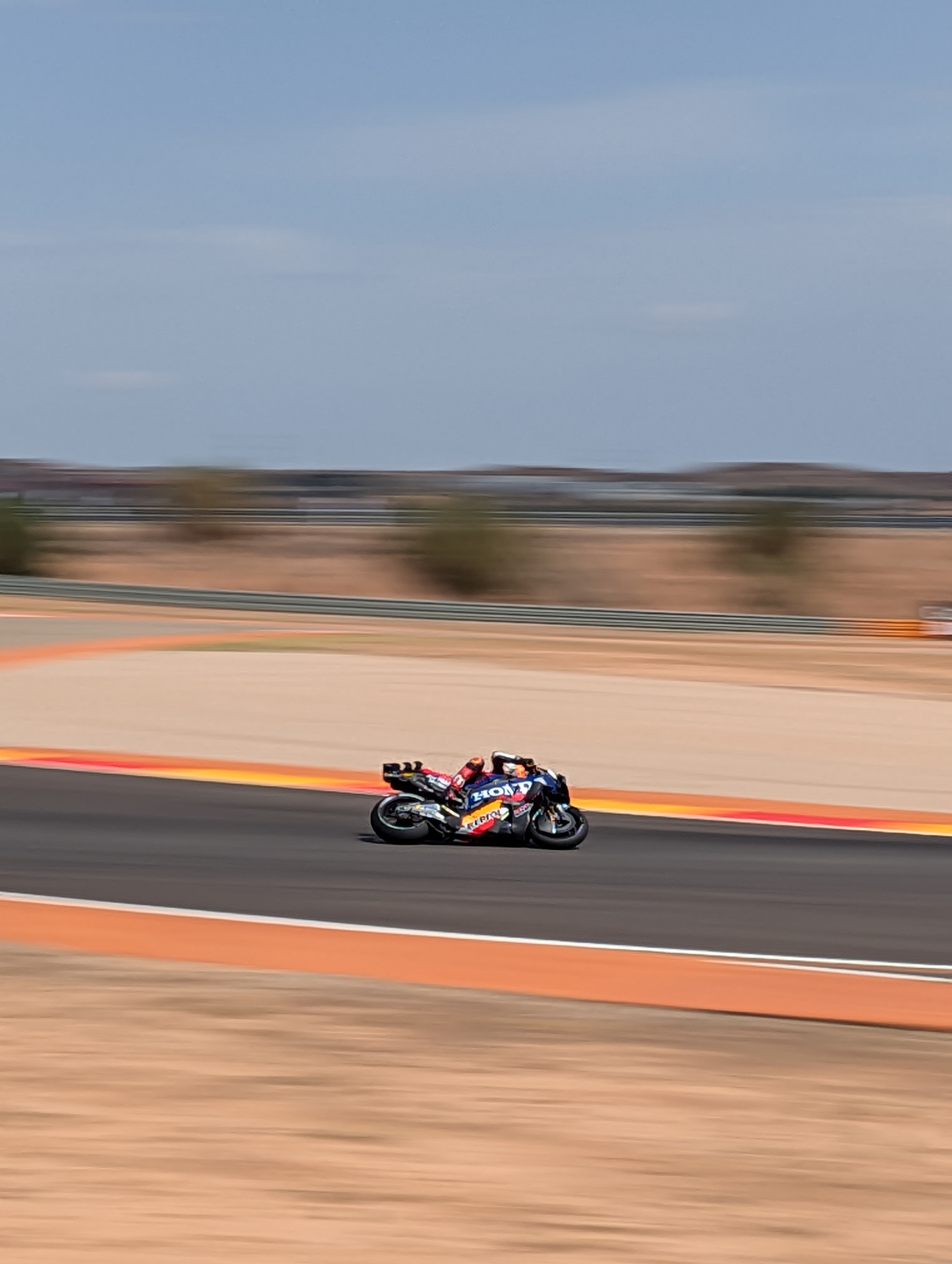 MotoGP riders at full speed on racetrack with action panning photography technique accentuating movement