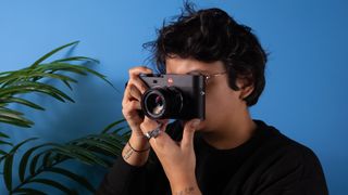 A woman holding a Leica M EV1