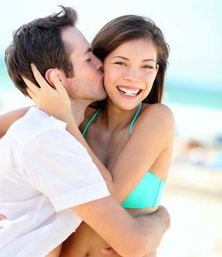 Happy couple kissing during summer