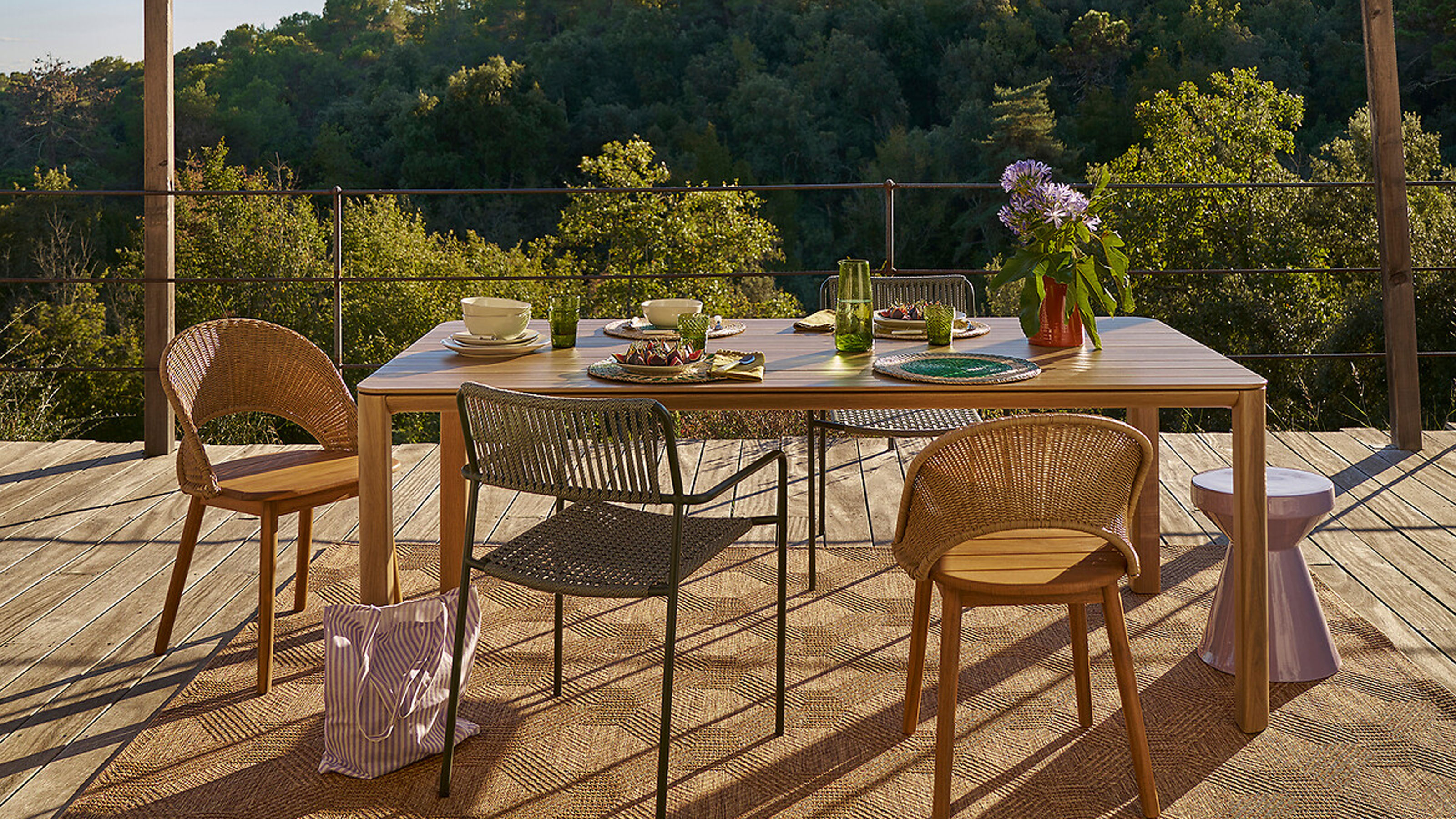 Wooden garden furniture with woven rug and an awning above