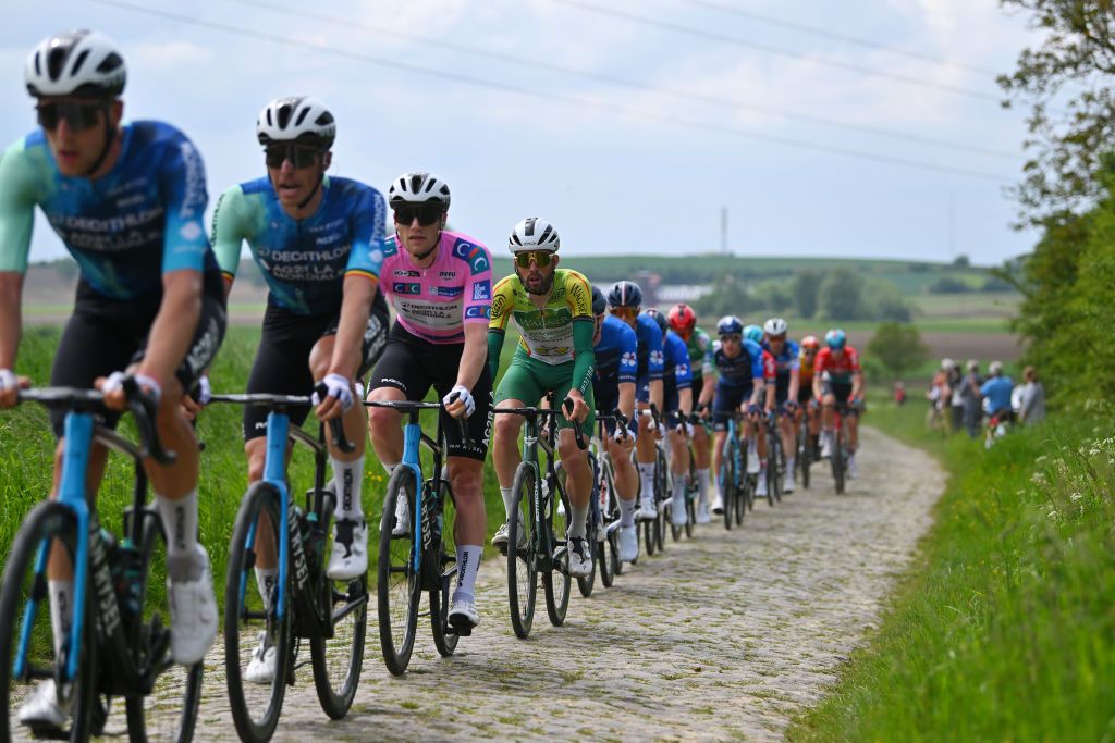 PONTMARCQ FRANCE MAY 17 Sam Bennett of Ireland and Decathlon AG2R La Mondiale Team Pink Leader Jersey competes passing through a cobblestones sector during the 68th 4 Jours de Dunkerque Grand Prix des Hauts de France 2024 Stage 4 a 1668km stage from Mazingarbe to PontMarcq on May 17 2024 in PontMarcq France Photo by Luc ClaessenGetty Images