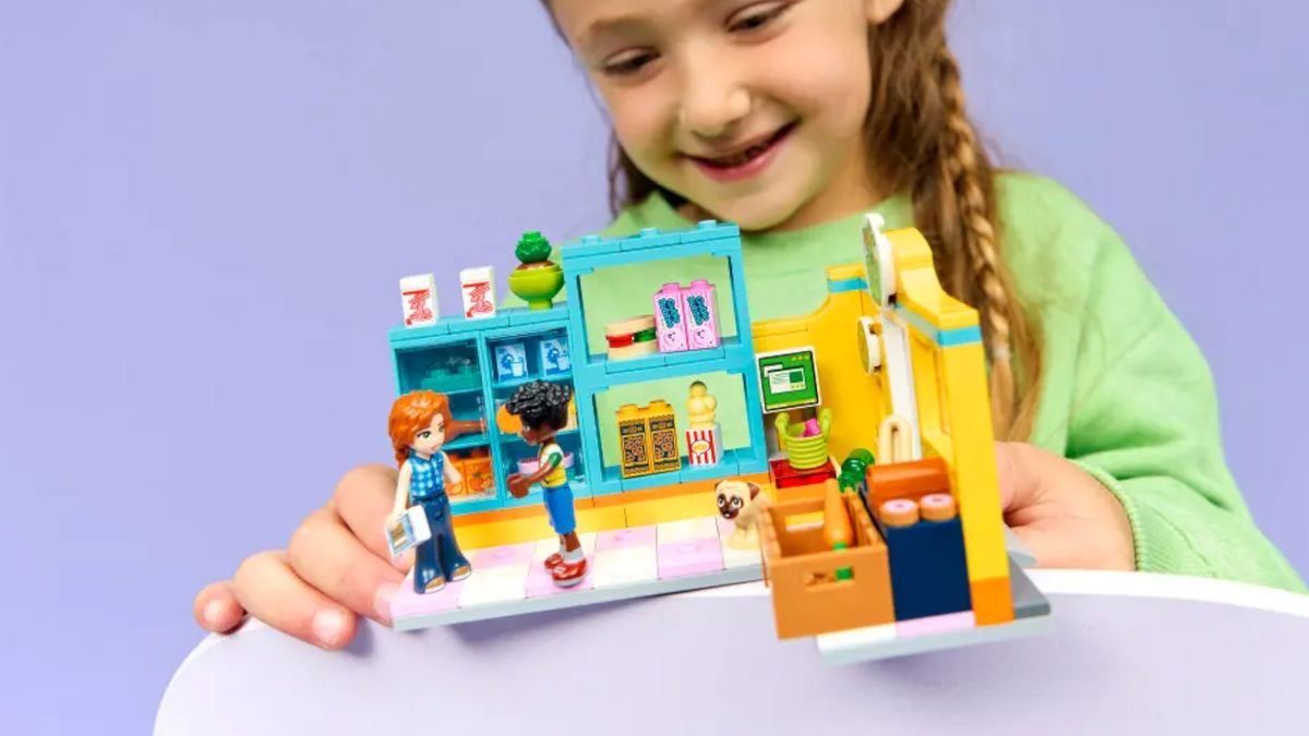 A child plays with a Lego shop set