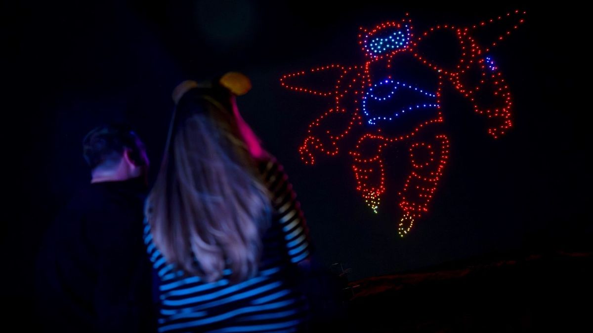 child watching drones in the form of Baymax in Dreams That Soar