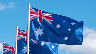 Multiple Australian Flags against blue sky