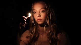 Cassie (Sydney Sweeney) lights a match on Euphoria