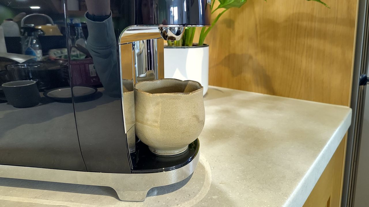 Cup placed on Lavazza A Modo Mio Smeg coffee maker drip tray