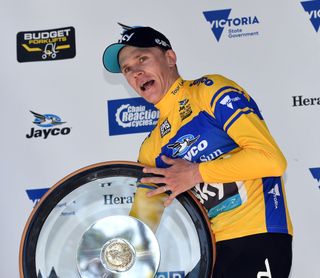 Chris Froome struggles to hold aloft his mammoth trophy after taking the stage and overall glory in the finale of the Herald SunTour