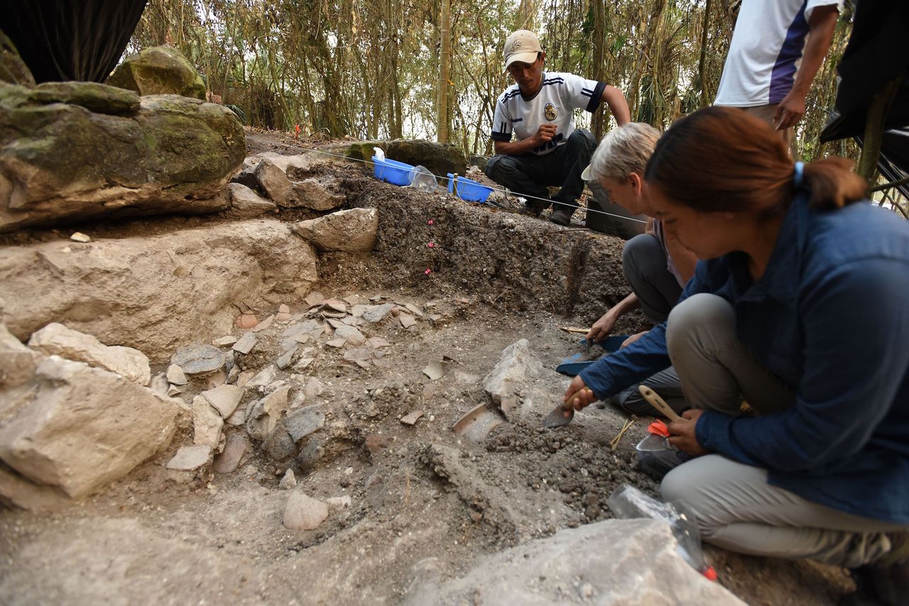 Study co-researcher Melina Garcia, an archaeologist with the Middle Usumacinta Archaeological Project in Mexico (right) and Daniela Triadan excavate a ceramic deposit at Aguada F&eacute;nix.