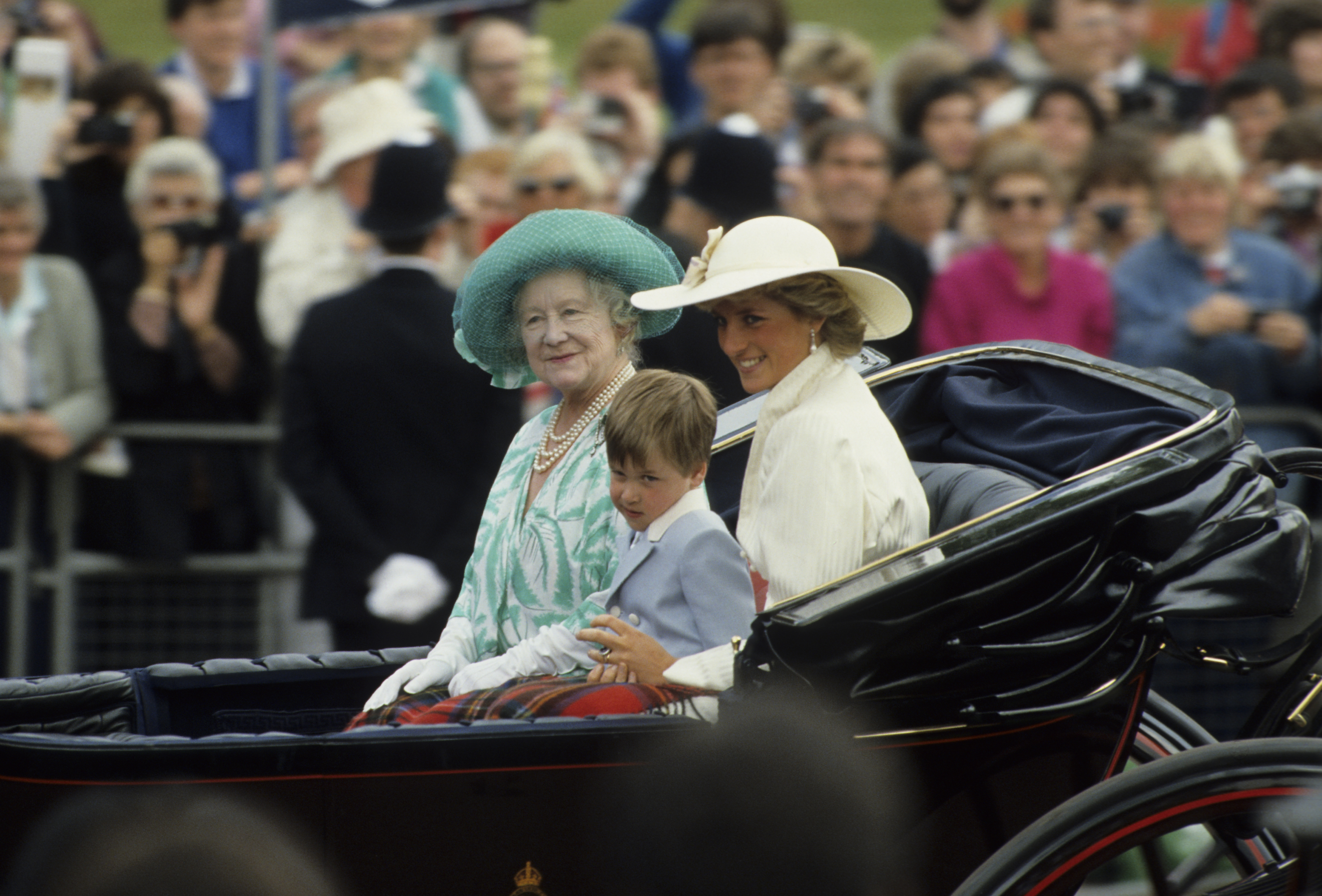 Princess Diana, the Queen Mother and Prince William riding in a carriage at Trooping the Colour