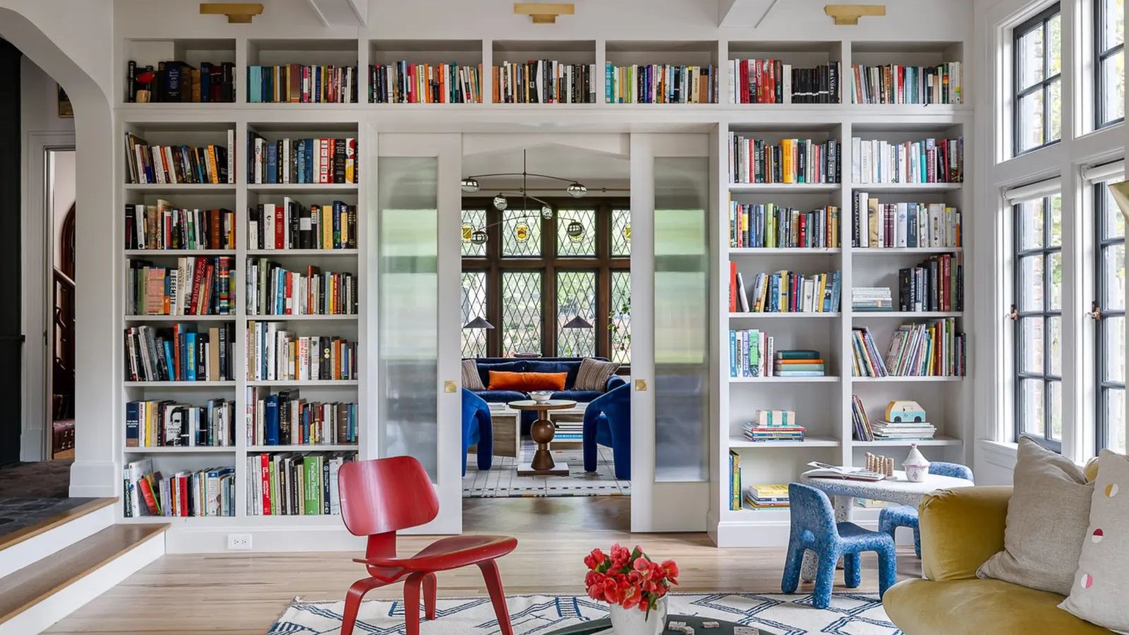 White living room with built in bookshelf across one wall