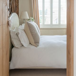 A side view of a bedroom through an open door