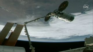 An uncrewed Northrop Grumman Cygnus NG-13 cargo ship is captured by a robotic arm at the International Space Station to deliver more than 7,500 lbs. (3,400 kilograms) of supplies to the orbiting laboratory on Feb. 18, 2020.